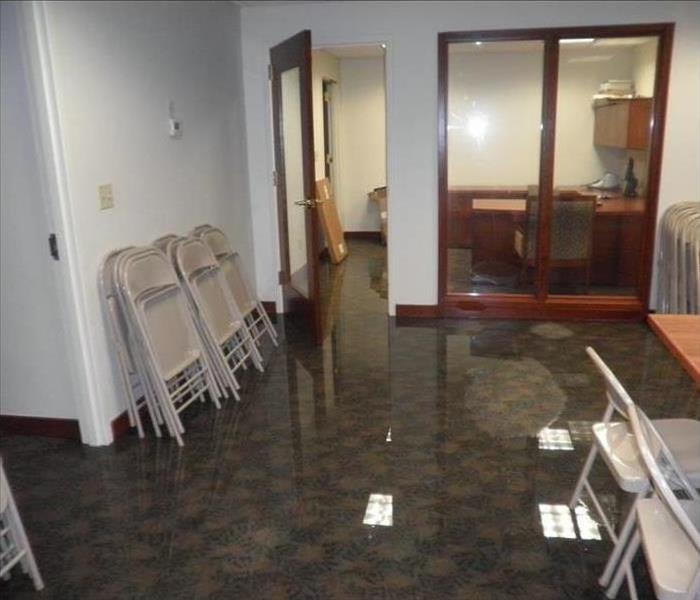 Office with standing water around fold-up chairs and table